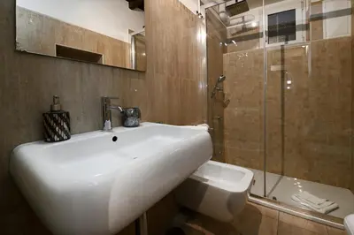 a bathroom with a white sink and a shower at Vicolo 22 - Residenze Romanae in Rome