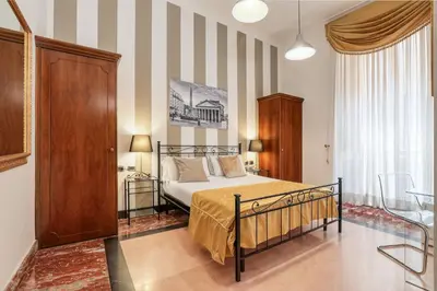 a bedroom with a bed and a striped wall at Spagna Dream Suites in Rome