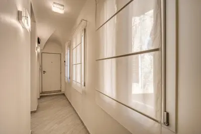 an empty hallway with a window and a door at Dimore Costaguti in Rome