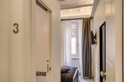 a hallway with a door to a room with a window at Dimore Costaguti in Rome
