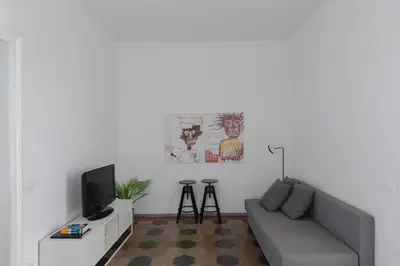 a living room with a couch and a tv at Vicoloft Sales in Rome