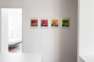 a group of pictures on a wall in a room at Vicoloft Sales in Rome