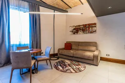 a living room with a couch and a table at Gasometer Urban Suites in Rome