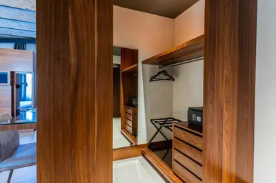 a bedroom with wooden cabinets and a tv in it at Gasometer Urban Suites in Rome