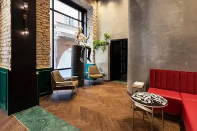 a living room with a red couch and chairs at Chapter Roma in Rome