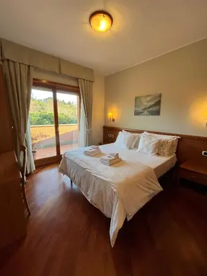 a bedroom with a large bed and a large window at Residenza 