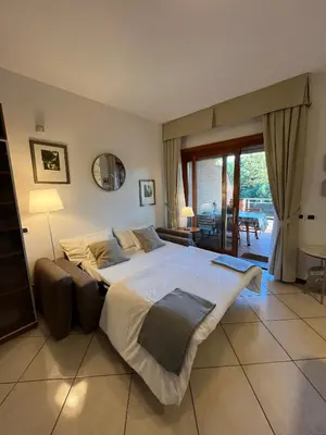 a large bed in a bedroom with a large window at Residenza 