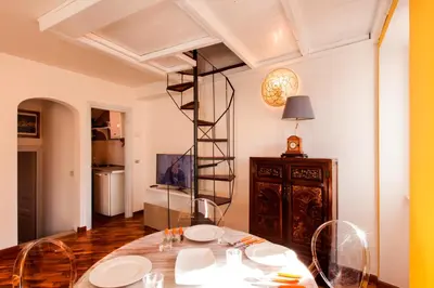 a dining room with a table with plates on it at Home D'elite Navona in Rome