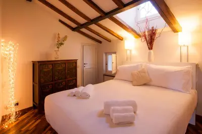 a bedroom with a white bed with towels on it at Home D'elite Navona in Rome