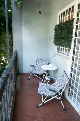 a patio with two chairs and a table on a porch at Next Stop Roma Affittacamere Da Florindo in Rome