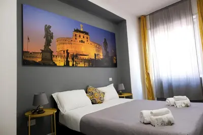 a bedroom with two beds and a painting on the wall at Vatican Central Suites in Rome