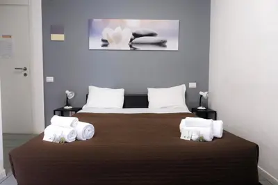 a bedroom with a large bed with towels on it at Vatican Central Suites in Rome