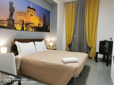 a hotel room with a bed and a tv at Vatican Central Suites in Rome