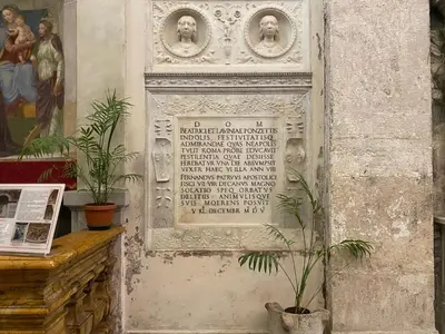 a plaque on the side of a building with statues at Domum Vaticani in Rome