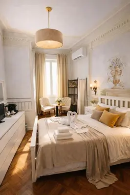 a bedroom with a large bed with two towels on it at Suites Piazza Del Popolo in Rome