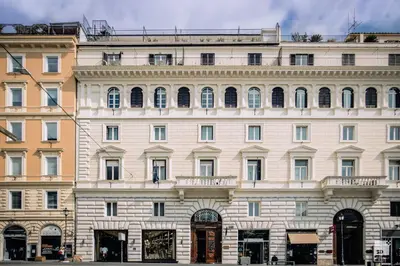 a large white building with a lot of windows at Hotel Boutique Nazionale in Rome