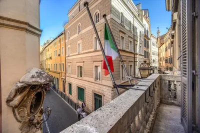 a flag hanging from a building in a city at Martius Private Suites Hotel in Rome