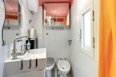 a small bathroom with a sink and a toilet at Il Nido in Rome