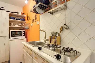 a small kitchen with a sink and a stove at Il Nido in Rome