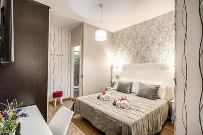 a bedroom with a bed with two stuffed animals on it at Santamaggiore in Rome