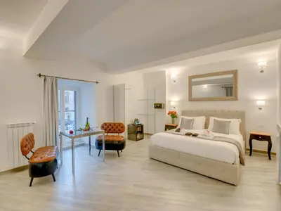 a bedroom with a bed and a table and a desk at Roma Suites Navona in Rome