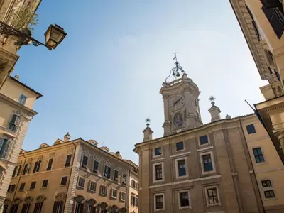 a building with a clock tower on top of it at Roma Suites Navona in Rome