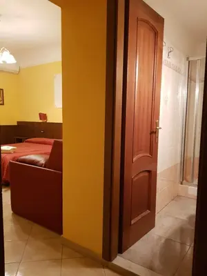 a door to a room with a bed and a couch at B&B Rudy in Rome