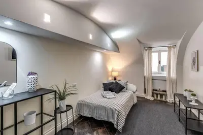 a living room with a bed and a window at Fori Imperiali Apartment in Rome