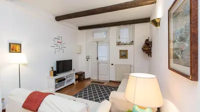 a living room with a white couch and a tv at Rental in Rome Panieri Terrace in Rome