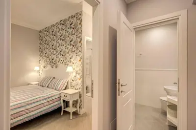 a small bedroom with a bed and a bathroom at Flat with terrace by Vatican in Rome