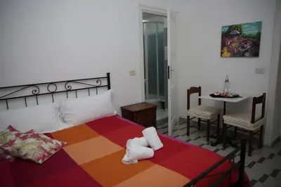 a bedroom with a large bed with a table and a tableablish at B&B Bel Ami in Rome