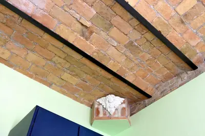 a brick wall next to a shelf in a room at Vintage 4 Bedrooms 20' Colosseum in Rome
