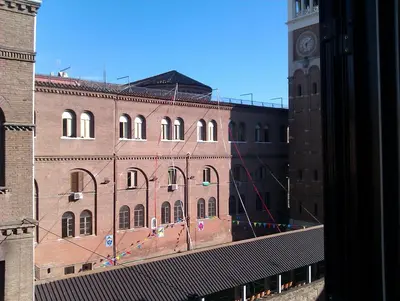 a large brick building with a clock tower at Vintage 4 Bedrooms 20' Colosseum in Rome