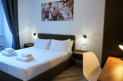 a hotel room with a bed with towels on it at THE ROMAN WAY San Giovanni in Rome