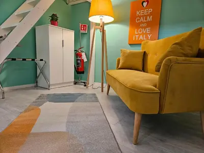 a living room with a yellow couch and a fire hydrant at 50 Passi Colosseo Apartment in Rome