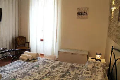 a bedroom with a bed and a window at 50 Passi Colosseo Apartment in Rome