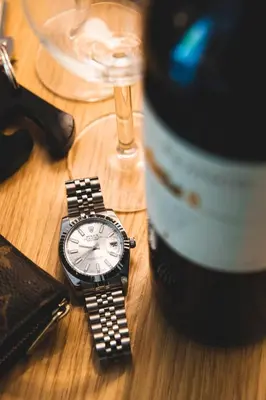 a watch sitting on a table next to a wine glass at Eccelso Hotel in Rome