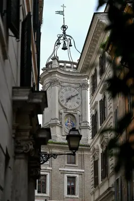 a clock tower on the side of a building at Sangallo Rooms - Residenze Romanae in Rome