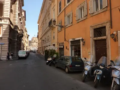a group of motorcycles parked on a street next to buildings at Sangallo Rooms - Residenze Romanae in Rome