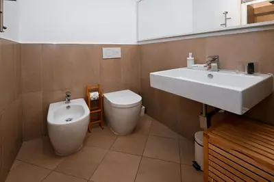 a bathroom with a sink and a toilet at Sangallo Rooms - Residenze Romanae in Rome