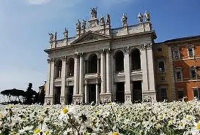 a large building with white flowers in front of it at Al Colosseo 8 in Rome