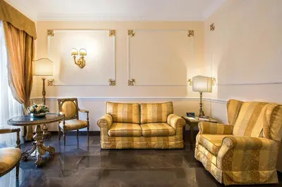 a living room with two chairs and a couch at Alta Luxury Apartments - Oca Apartment in Rome