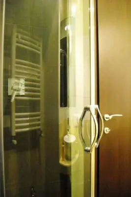 a bathroom with a shower with a glass door at B&B Il Granello Di Senape in Rome