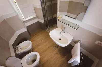 a small bathroom with a toilet and a sink at Angelina Rooms in Rome in Rome