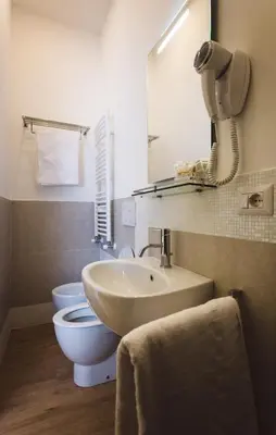 a bathroom with a sink and a toilet and a mirror at Angelina Rooms in Rome in Rome