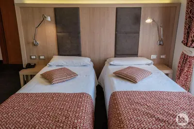 two beds in a hotel room with two beds sidx sidx sidx at Hotel Casa Valdese Roma in Rome