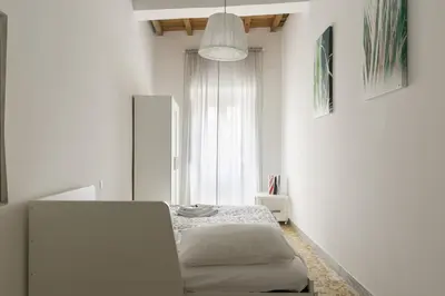 a white room with a bed and a table at Art Apartment Navona Square in Rome