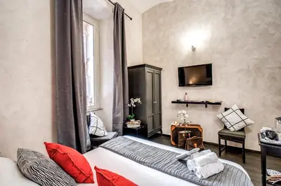 a hotel room with a bed and a tv at La Residenza Dell'Angelo in Rome