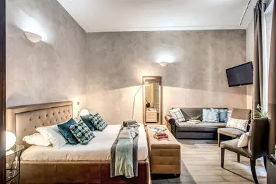 a living room with a bed and a couch at La Residenza Dell'Angelo in Rome