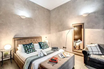 a bedroom with a large bed and a couch at La Residenza Dell'Angelo in Rome